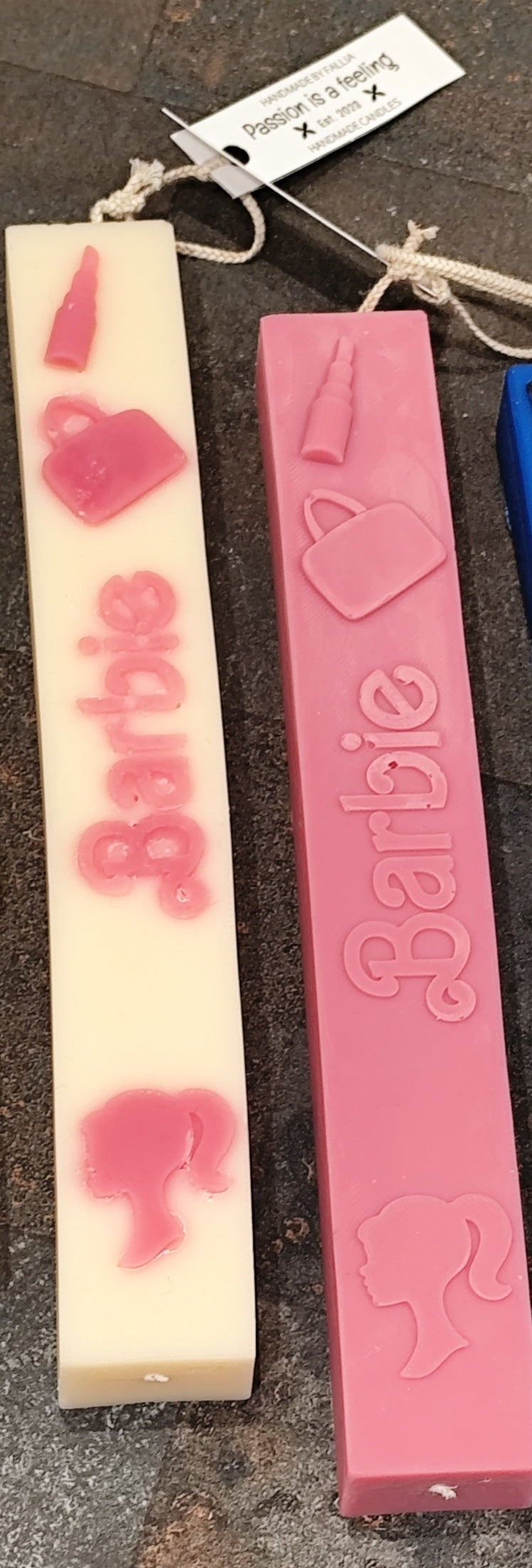 Two Barbie-themed Easter candle with pink hearts on a textured surface.