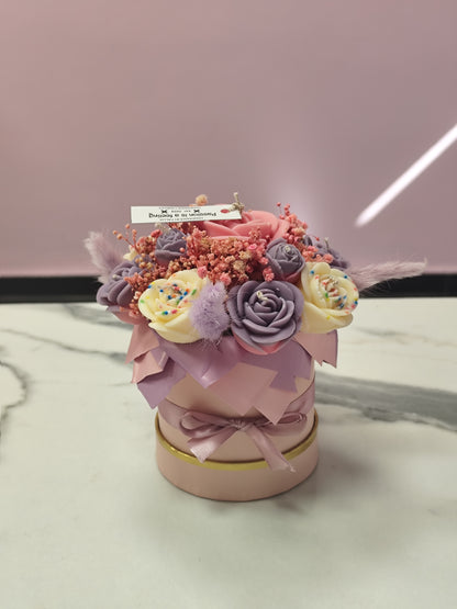 Decorative candle flower  a pink container on a marble surface with a blurred background