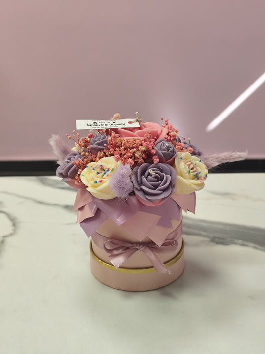 Decorative candle flower  a pink container on a marble surface with a blurred background