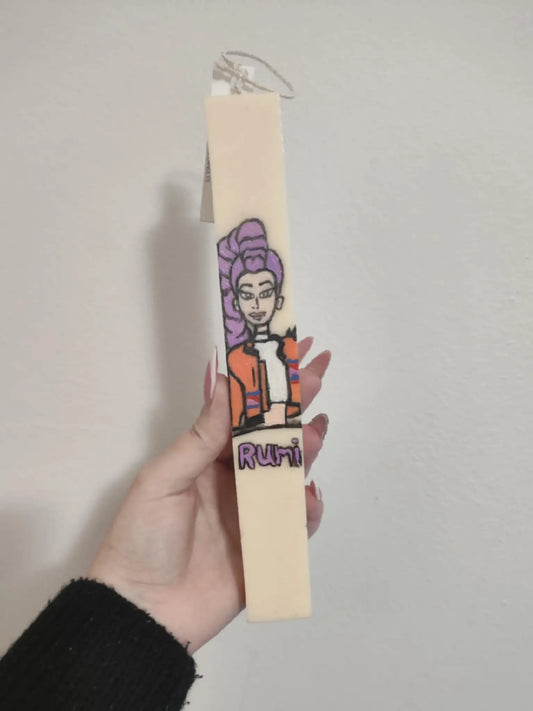 candle with a cartoon character and 'Rumi' text on a plain background