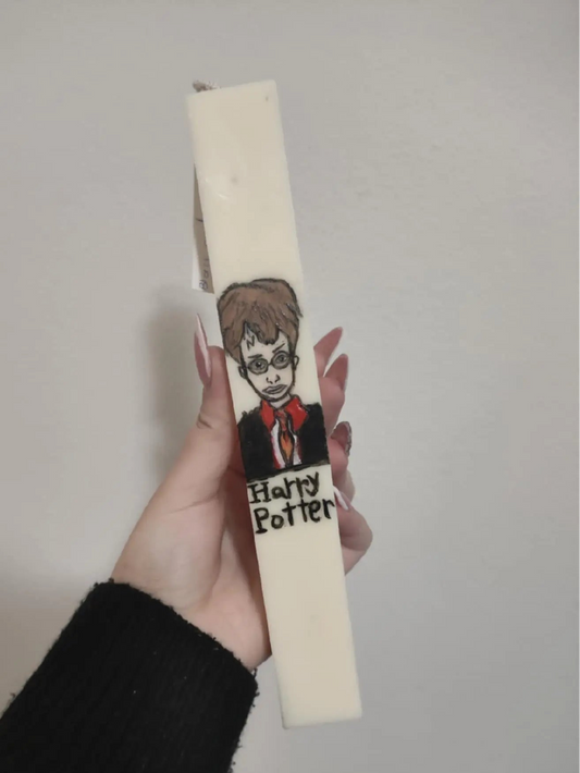 candle with a 'Harry Potter' design on a plain background