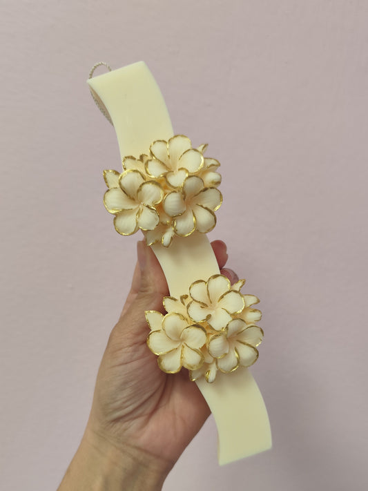  floral designs  easter candle by a hand against a pink background